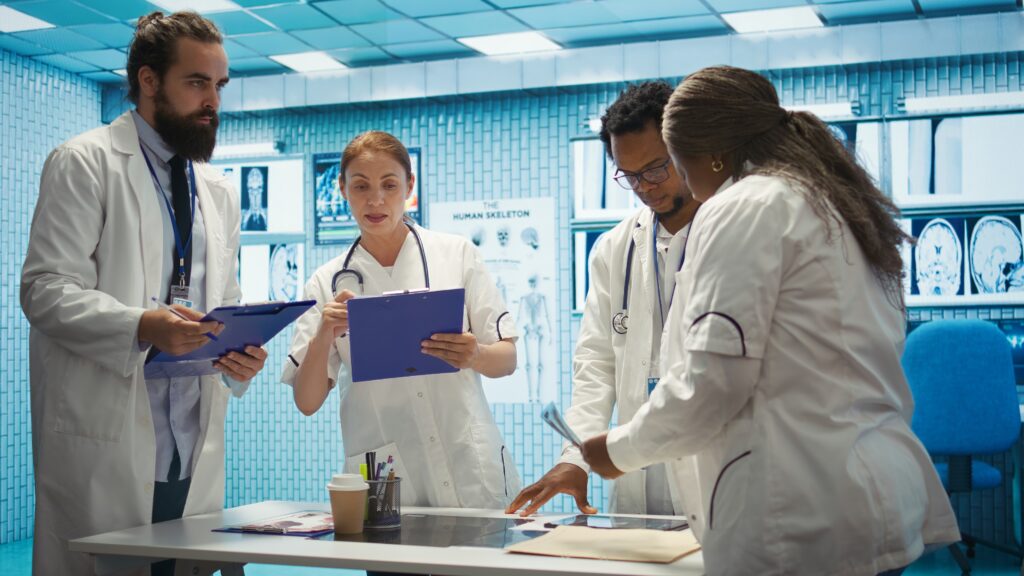 group of healthcare workers analyzing diagnostic data and planning treatment